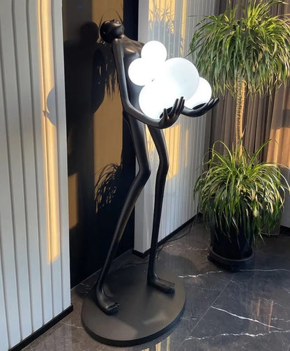 Strong MAN holds balls floor lamp