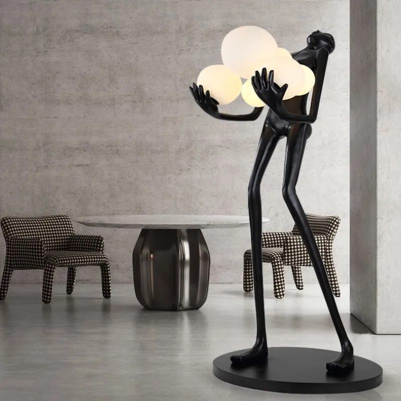 Strong MAN holds balls floor lamp