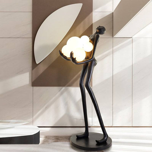 Strong MAN holds balls floor lamp