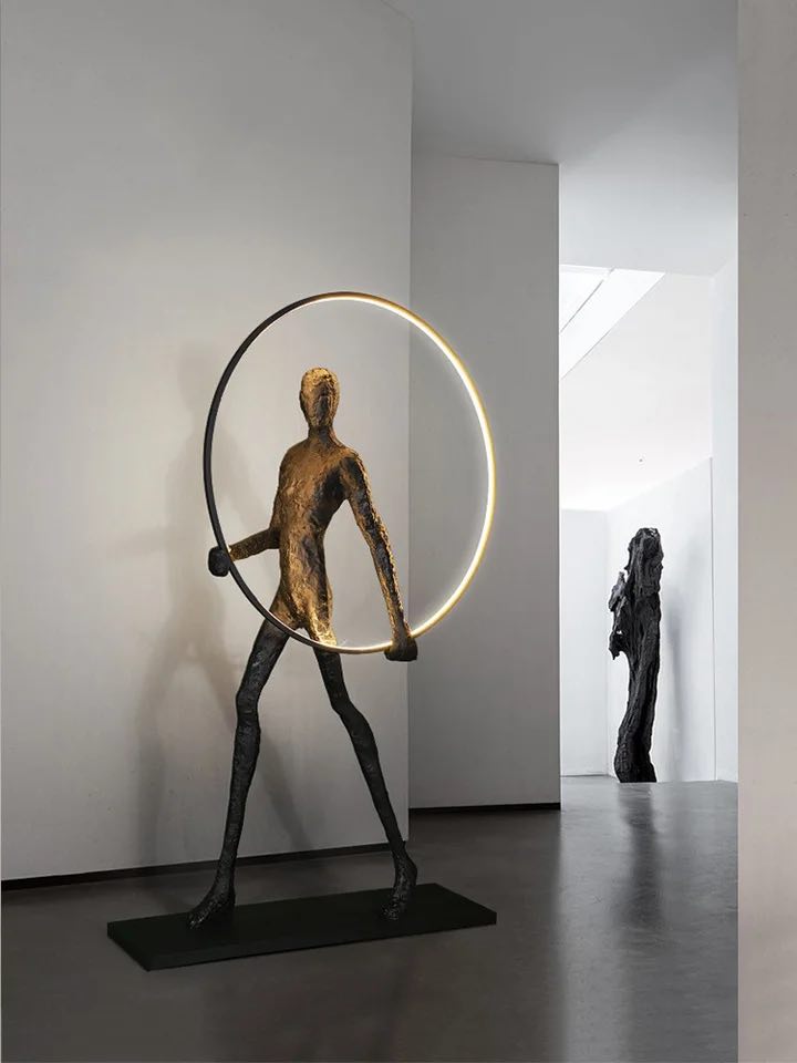 Man with a ring floor lamp